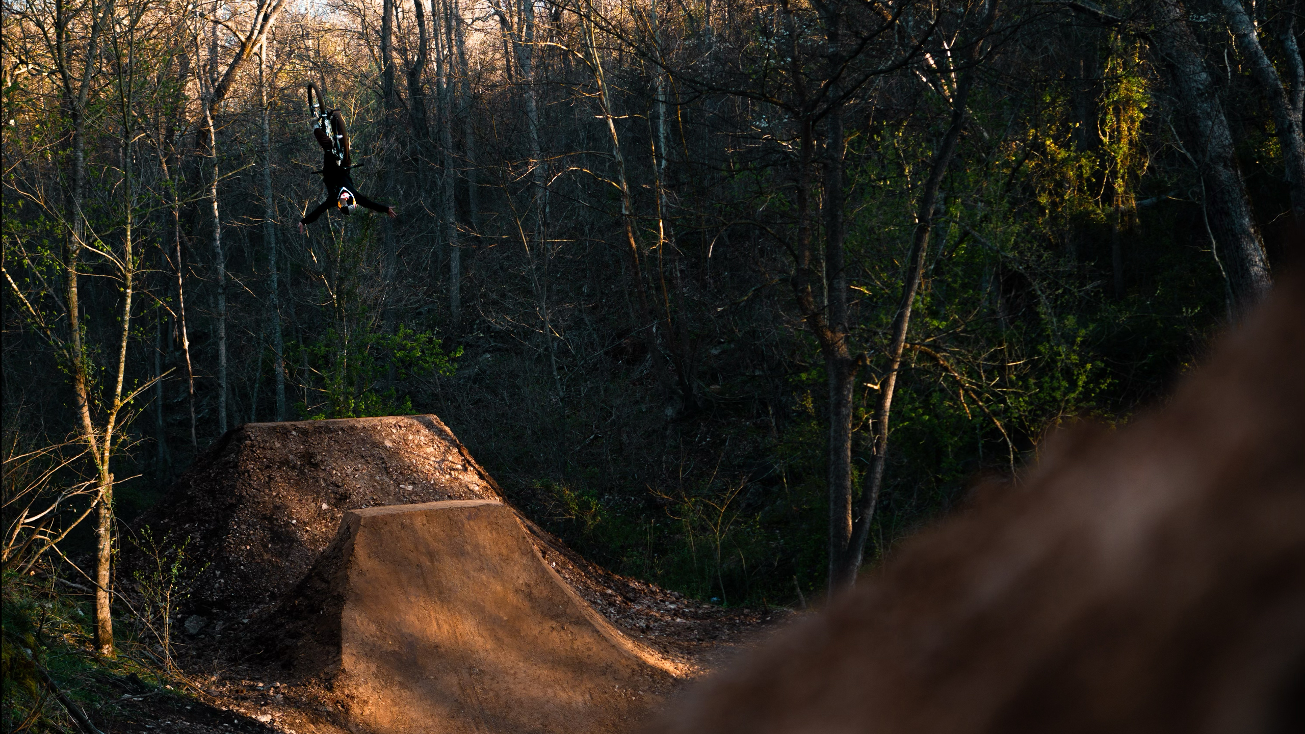 Freestyle mountain-bike athlete in flight over the LINE jump environment