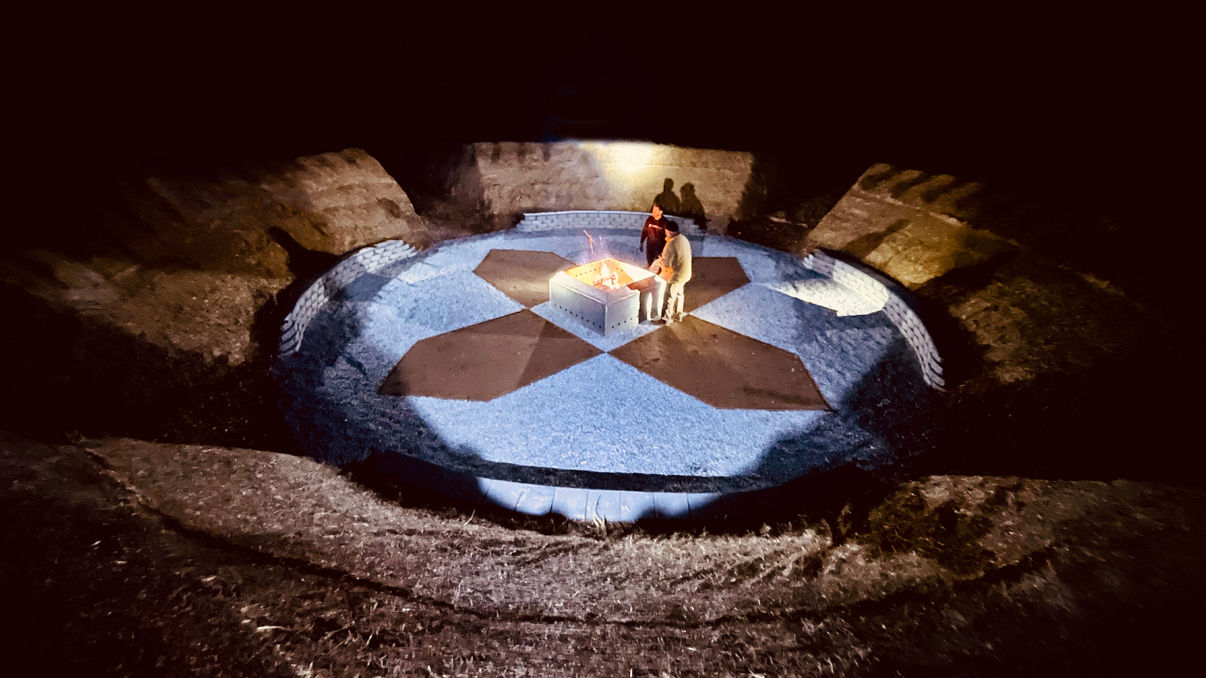 Central fireplace illuminated inside SPACE at night